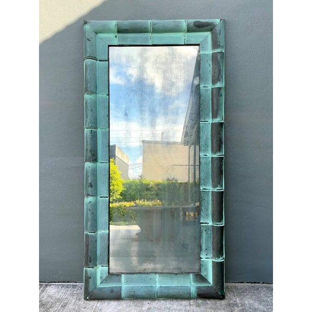This vintage patinated copper shingle floor mirror by Olde Good Things makes a bold architectural statement through its...