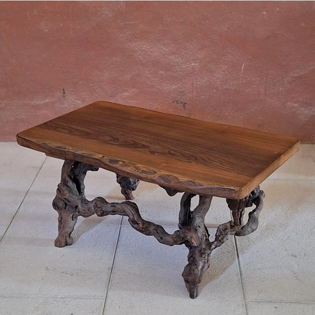 This table features a solid oak top and vine wood legs.