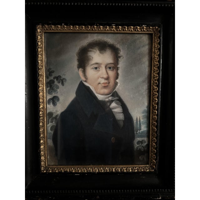 A charming pair of portraits depicting a bourgeois couple from the early 19th century. The gentleman, dressed in a blue...