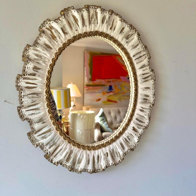 Vintage 1960s Hollywood Regency gold and cream ruffled plaster oval mirror from Syracuse Ornamentals. It can either be...