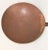 An antique handmade copper cooking utensil. Large round slightly concave disk with attached hand forged handle. Measures...