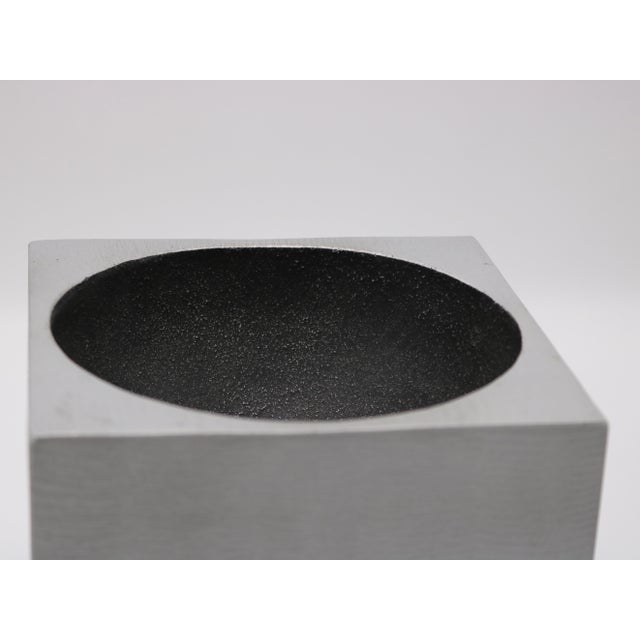 A Modernist cube sculpture. By artist Lorenzo Burchiellaro. Textured cast aluminum with concave top and side details....