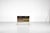 "DF 2000" desk with a pull-out shelf and two molded plastic drawers in a gradient of colors, transitioning from dark brown...