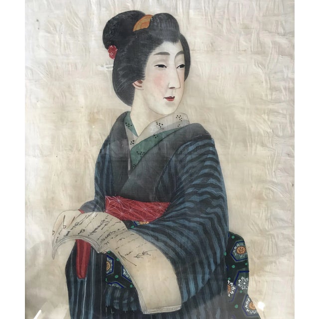 Two portraits of Japanese man and women in traditional costume painted on silk in their original frames.