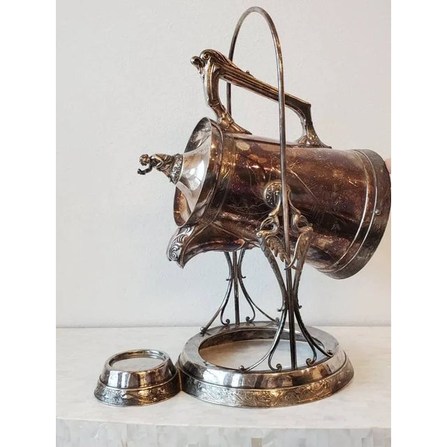 A magnificent classical American fancy silver plated ice water pitcher and swing stand serving set. Circa 1860s...