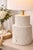MOBILE-READY DESCRIPTION A sculptural coastal table lamp featuring a fluted column base in a soft whitewashed finish with...