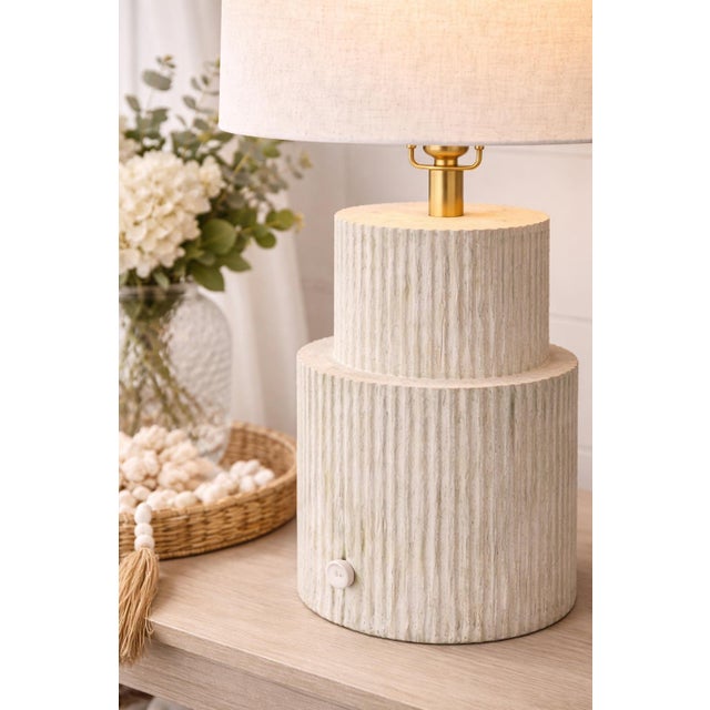 MOBILE-READY DESCRIPTION A sculptural coastal table lamp featuring a fluted column base in a soft whitewashed finish with...