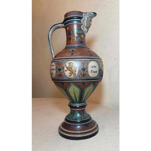 Up for sale is a huge antique handmade German painted pottery beer ewer, featuring intricate armorial designs done in high...