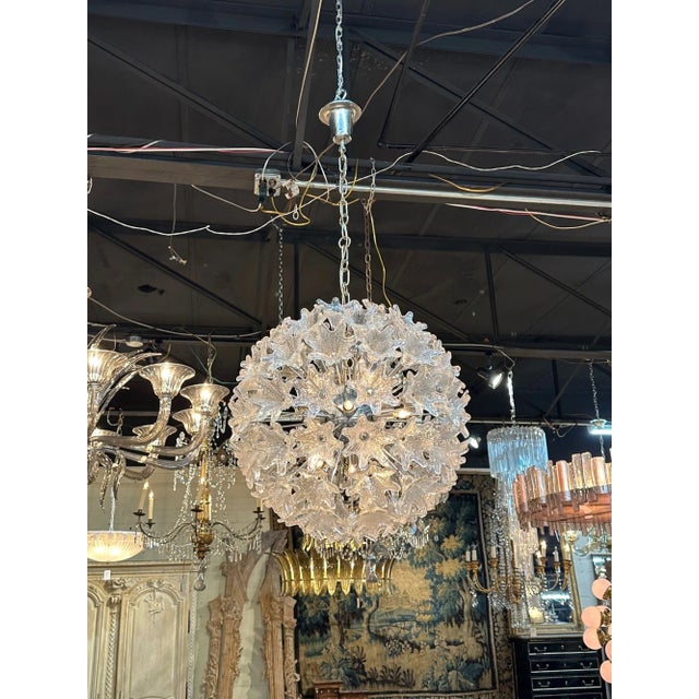 Gorgeous vintage Murano glass globe shaped sputnik chandelier. Features beautiful Murano flowers. Creates a high-end...