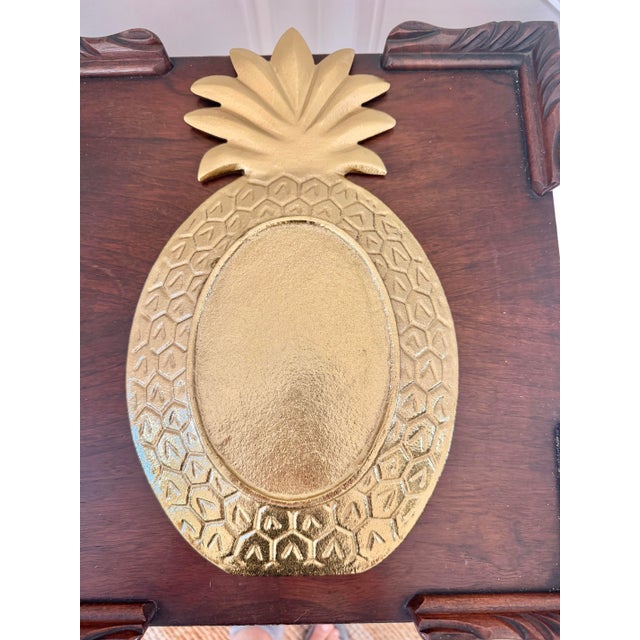 Sculptural gold-tone pineapple serving tray crafted from substantial cast aluminum. The elongated pineapple form features...