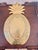Sculptural gold-tone pineapple serving tray crafted from substantial cast aluminum. The elongated pineapple form features...