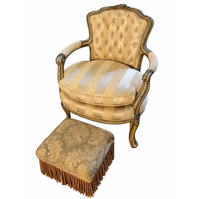 An elegant Louis XV–style armchair paired with a coordinating damask footstool. The chair features a shaped, button-tufted...