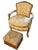 An elegant Louis XV–style armchair paired with a coordinating damask footstool. The chair features a shaped, button-tufted...