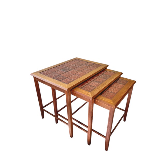 A set of 3 nesting tables, stamped ‘Made in Denmark’, 1960s. Sleek yet graceful design, the tables can hang ‘inside each...