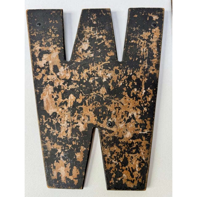Set of eight large vintage wall letters with heavily worn black and brown-tone surfaces. Made from thin pressed hardboard...