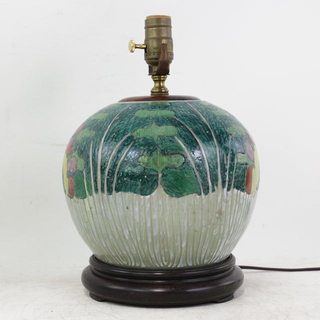 This antique table lamp is expertly crafted from an authentic porcelain vessel featuring the traditional and highly...