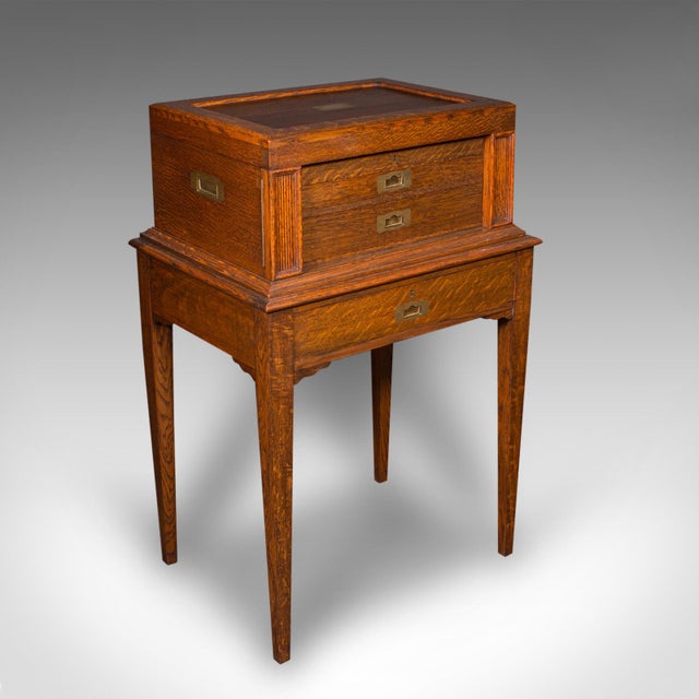 This is an antique dining hall canteen on stand. An English, oak and silver plated 12 person cutlery set, dating to the...