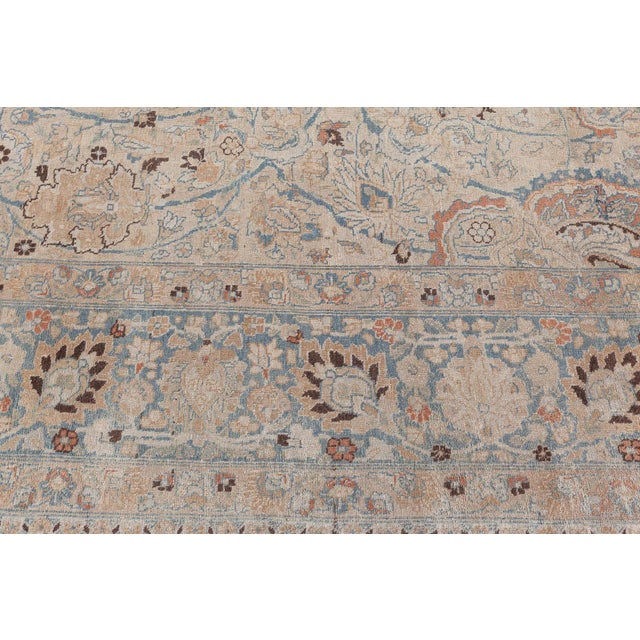 This circa-1920 antique Persian Khorassan rug features an intricate all-over design of floral abstractions, arabesques,...