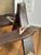 A classic mid-century camel saddle stool featuring a rich, patinated hardwood frame and its original contoured leather...