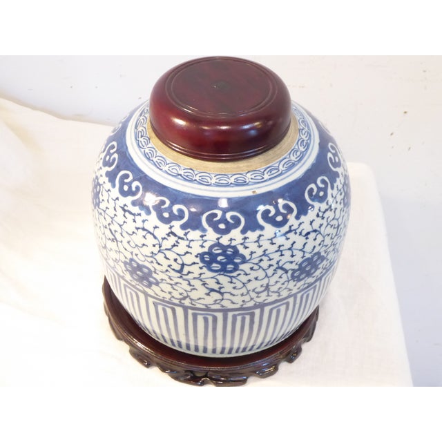 This 19th Century hand painted ginger jar with lotus pod design comes with a hardwood cover and base.