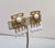 1960s goldtone Asian character with cabochon white rhinestone in the center with four ovoid white bead drops clip back...