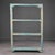 This open étagère is constructed in pine with four square-section corner uprights supporting three intermediate shelves...