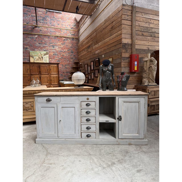 This handcrafted sideboard features a gray-patinated frame and a solid oak top. It has three large solid doors that open...