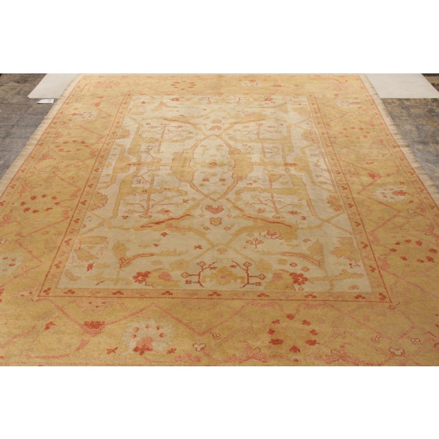 Made with hand-knotted wool and originating from Turkey circa 1950-60, this 10x13 vintage Oushak rug is a regal find in...