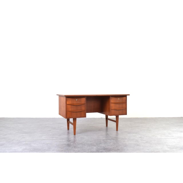 This teak desk was manufactured in Denmark in the 1960s. It has been professionally and carefully restored by removing old...