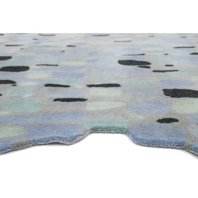 This beautiful, modern hand-tufted wool rug part of our Laura Gottwald for Apadana Collection features gray, black, blue,...