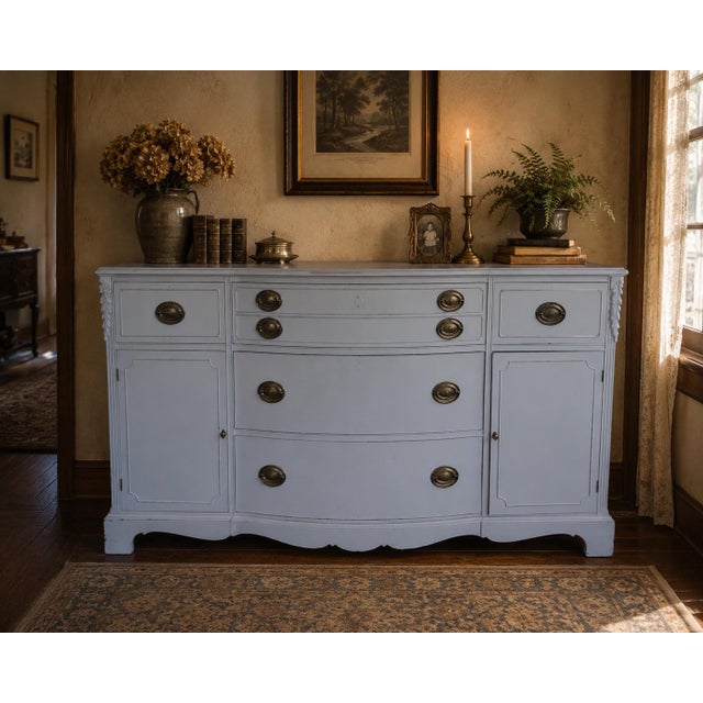 A beautifully crafted vintage French Provincial buffet featuring elegant serpentine lines, carved corner details, and...