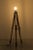An industrial floor lamp with three legs. The base is made of a land surveying device. The floor lamp does not include a...