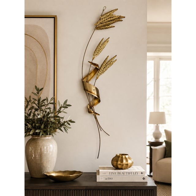 Add timeless Mid-Century Modern elegance to your home with this vintage brass-tone metal wall sculpture featuring stylized...