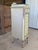 A charming vintage cottage-style tall chest featuring its original hand-painted distressed finish in soft cream, seafoam...