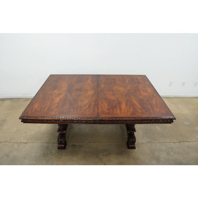 This vintage Theodore Alexander Revival Style extendable mahogany dining table is a substantial statement piece with a...