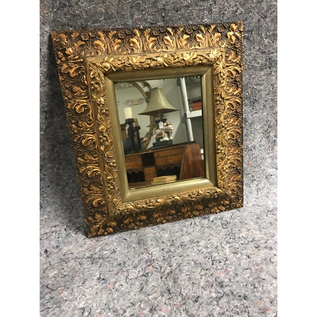 Antique carved pine framed mirror. Gold and bronze colored leaf motif. Very pretty.