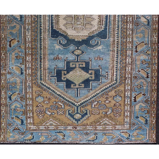 Antique Persian rug with a blue field and brown cornices with a blue border. Keivan Woven Arts, rug EMB-9713-P13901,...