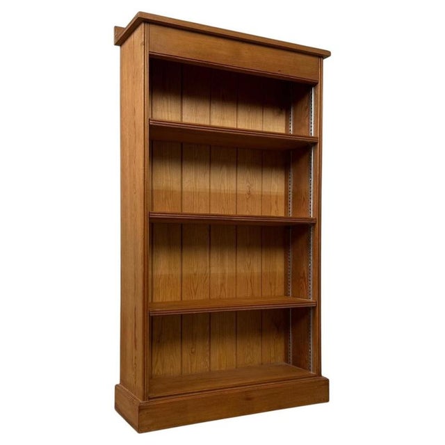 A charming vintage 20th-century English open bookcase, well crafted from pine and offering an attractive combination of...