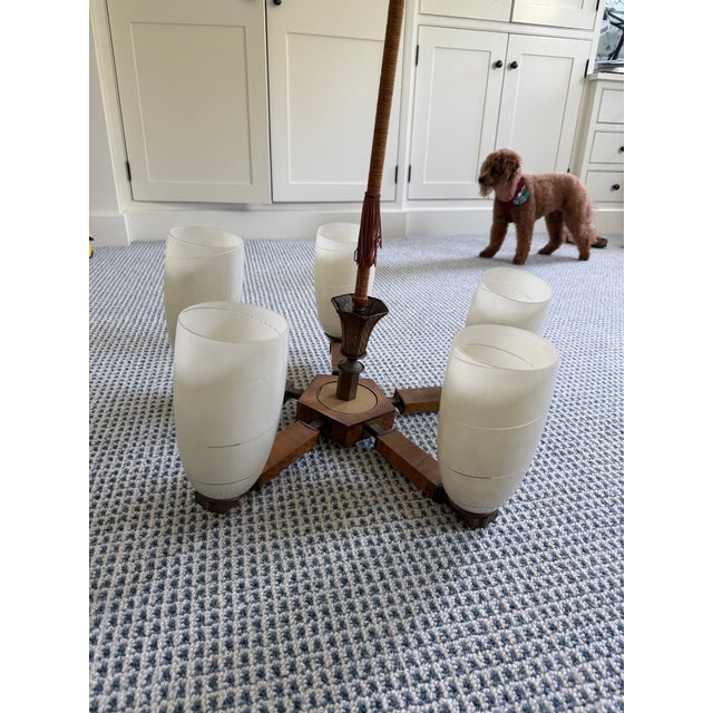 1970s Mid-Century chandelier made by Inva Litomerice in Czechoslovakia, featuring wood and frosted glass shades. In...