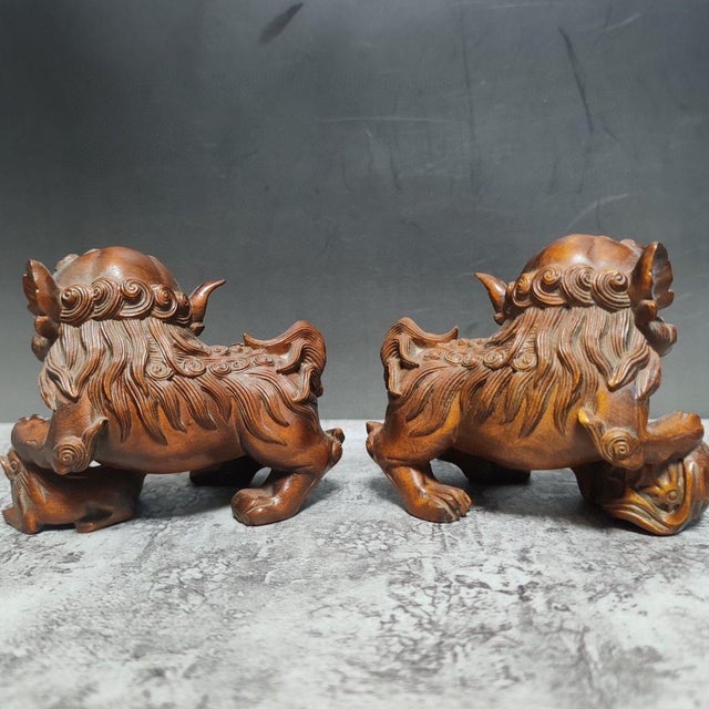 This elegant pair of lions is finely hand-carved from premium boxwood (Huangyang wood), prized for its smooth grain and...