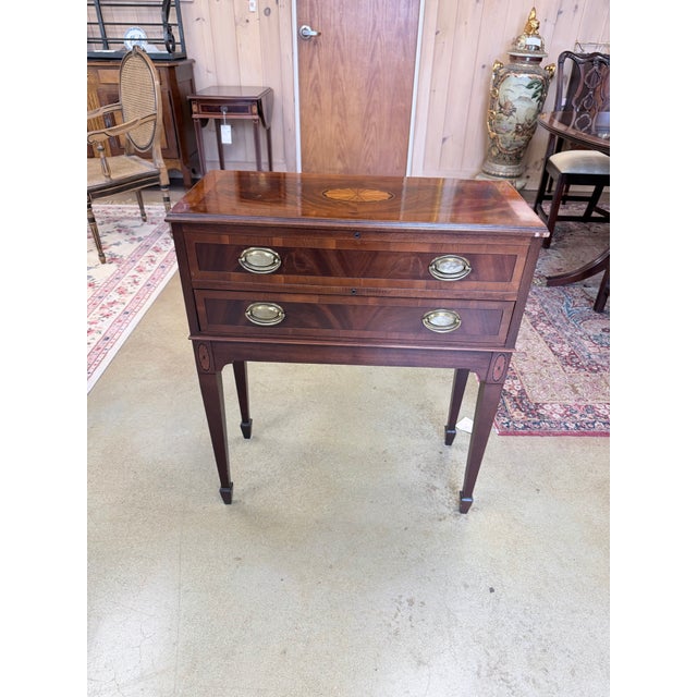 A finely composed Hekman flatware storage chest that reflects classic Georgian influence through its balanced proportions...