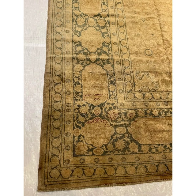 This 19th century Turkish Oushak rug features a beautifully aged and softly muted composition defined by a warm gold to...