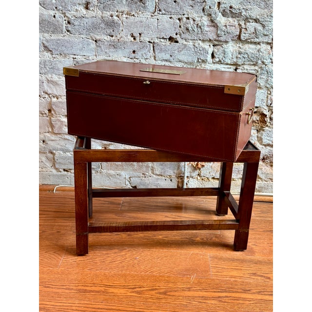 This Leather Campaign Box on a solid wood stand combines refined craftsmanship with practical design. Measuring 22.5" x...