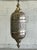 Infuse your home with the exotic allure of this stunning vintage Moroccan lantern. Handcrafted from silver-toned metal,...