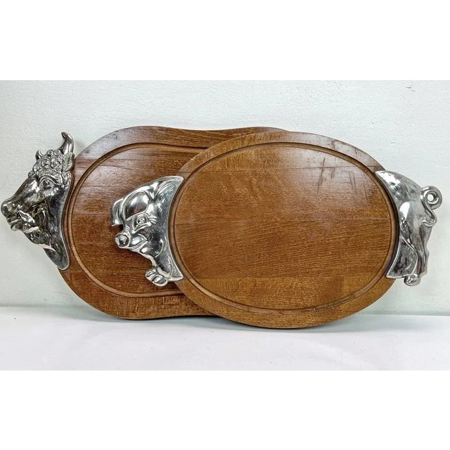 a set of meat cutting boards made in the 1950s by bmf germany. very decorative in the shape of an ox and a pig, which are...