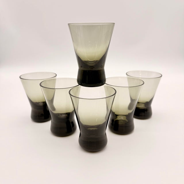 These mid-century glasses are the "Pingviini" (Penguin) series designed by renowned glass artist Helena Tynell for the...