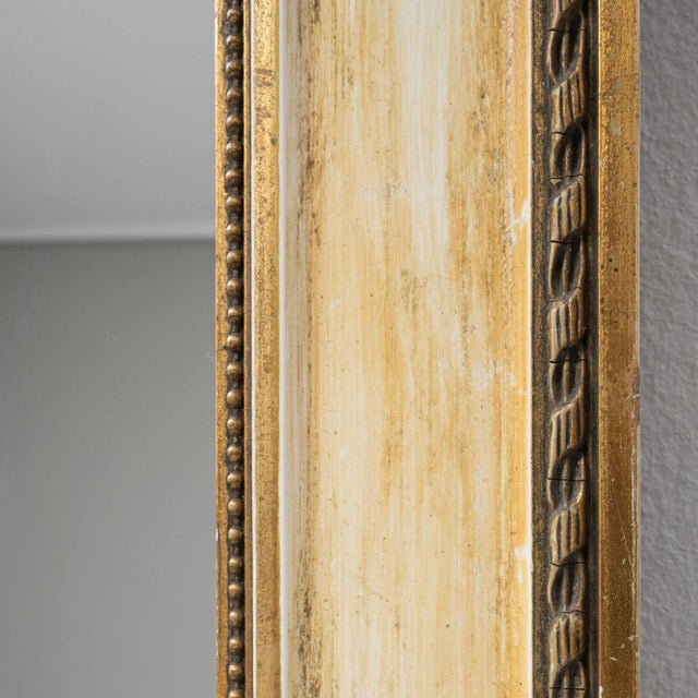 Discover the allure of the early 20th Century with this French gilded wood mirror, a piece that radiates historic charm...