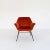 Single armchair with new lobster-colored upholstery and black painted metal structure.