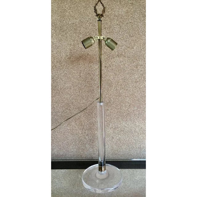 "brass lamp Circa 70" Large acrylic glass foot lamp adorned with a brass ring at the base of lights slaughtered in average...