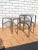 Set of 3 chrome nesting tables. With smoked glass. Simple yet elegant archway design. Each smaller table fits under the...